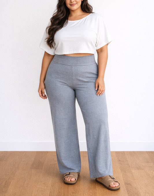 Woman wearing a white top and gray Plus Size Flared Knit Pants on a plain background