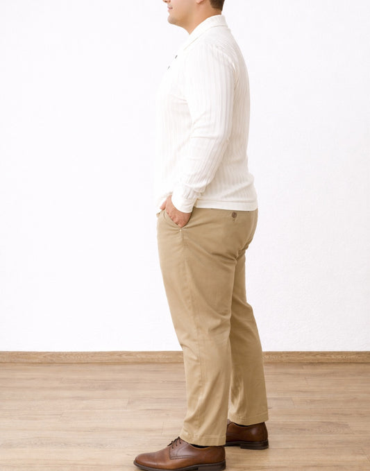 Side view of man wearing a white ribbed Plus Size Long Sleeve Polo Shirt and beige pants on a plain background.