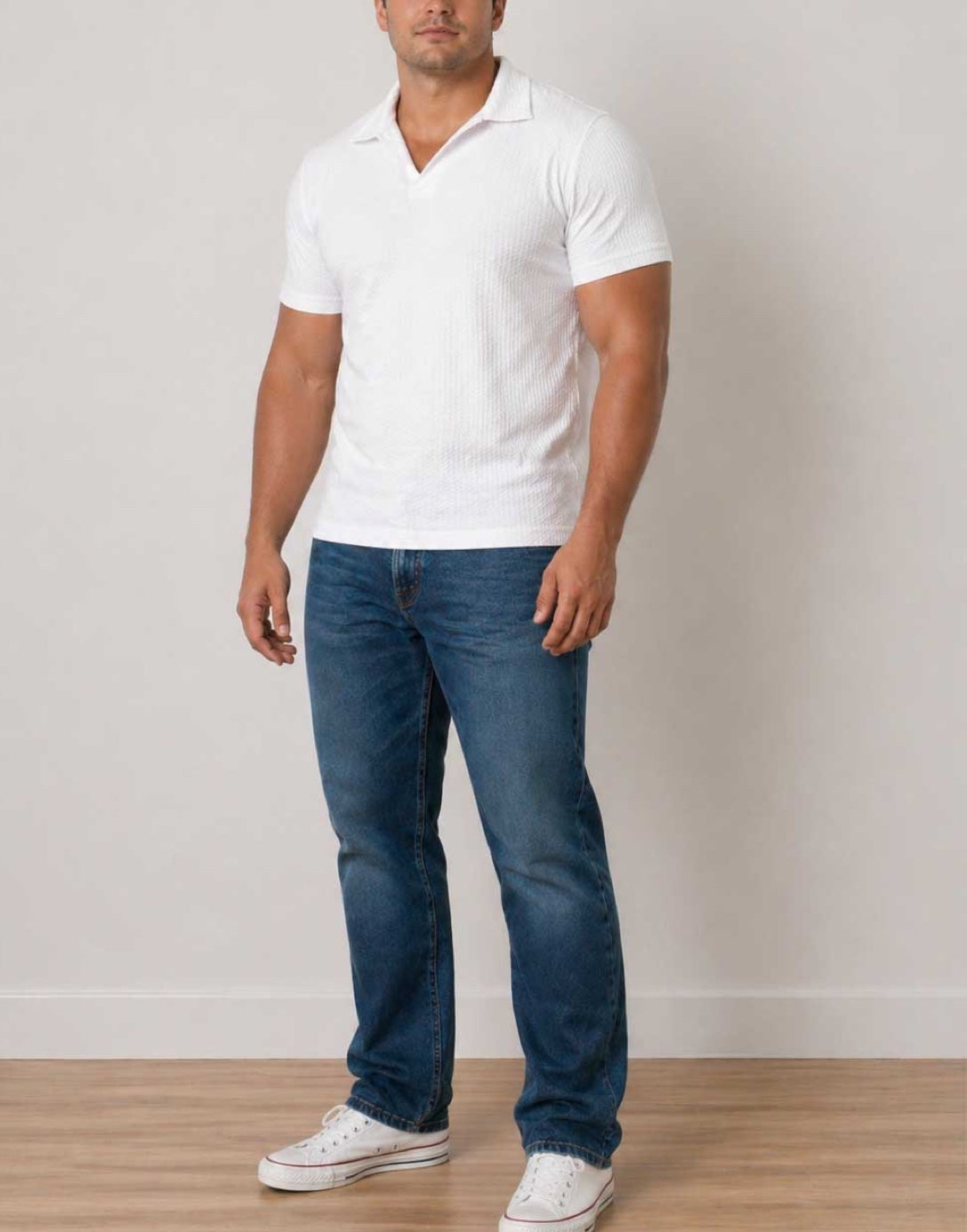Side view of man wearing a white Plus Size Mens Knit Shorts Sleeve Polo Shirt with blue denim jeans on a white background.