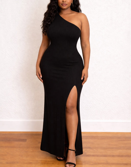 Woman wearing a black Plus Size One Shoulder Maxi Dress with a high slit on a white background