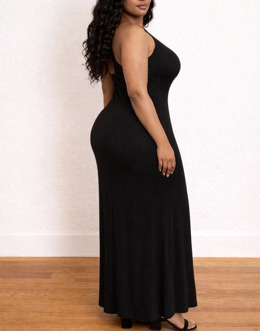 Side view of woman wearing a black Plus Size One Shoulder Maxi Dress on a white background.