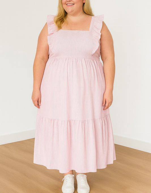 Woman wearing a pink Plus Size Square Neck Maxi Dress with ruffled straps on a plain background