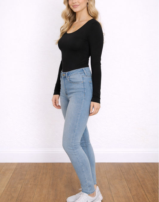 Side view of woman wearing a black Scoop Neck Long Sleeve Top and light blue jeans on a white background.
