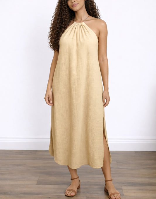 Woman wearing a beige Side Slit Halter Neck Maxi Dress on a white background