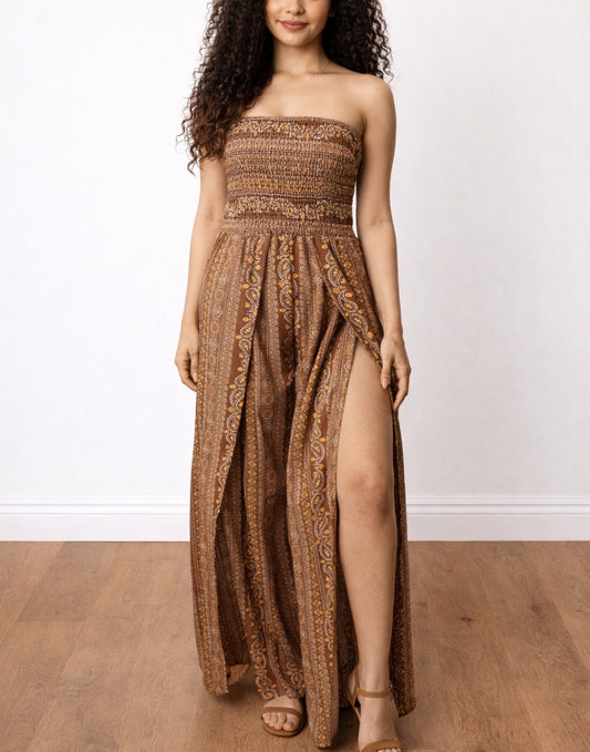 Woman wearing a brown strapless Split Thigh Shirred Tube Jumpsuit with a slit on a white background.