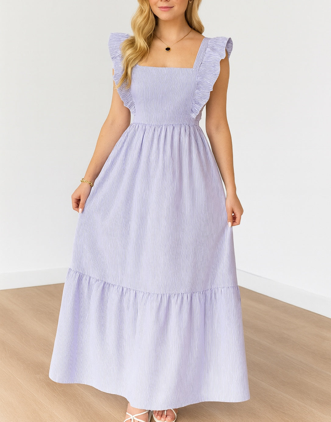 Woman wearing a light purple Square Neck dress with ruffled sleeves on a white background.