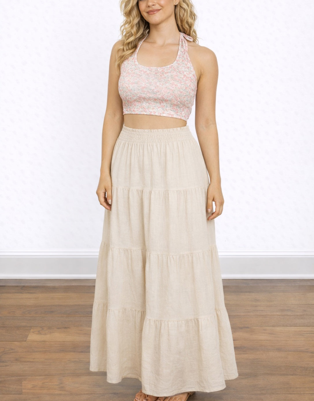 Woman wearing a Tie Backless Halter Top and long beige skirt on a white background