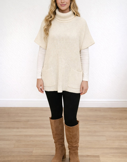 Woman wearing a cream Turtleneck Pocket Sweater Dress, black leggings, and brown knee-high boots on a white background.