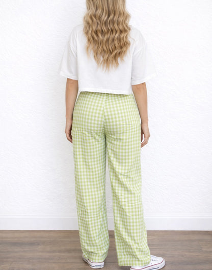 Back view of woman wearing a white cropped top and green checkered Wide Leg High Waist Pants against a white background.