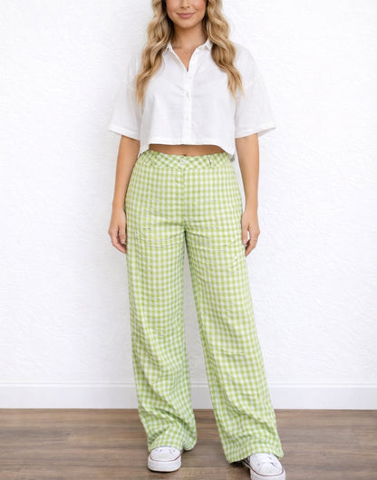Woman wearing a white cropped top and green checkered Wide Leg High Waist Pants against a white background