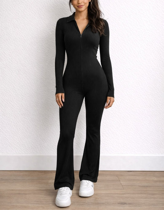 Woman wearing a black Zip Up Flare Leg Jumpsuit with a white background.